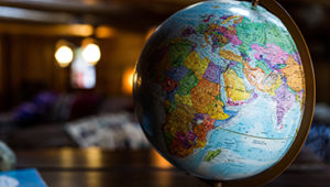 A globe showing continents against a blurred background